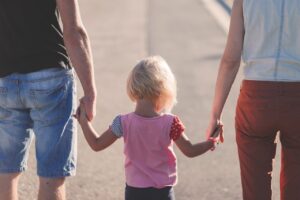 parents holding kids for their hands