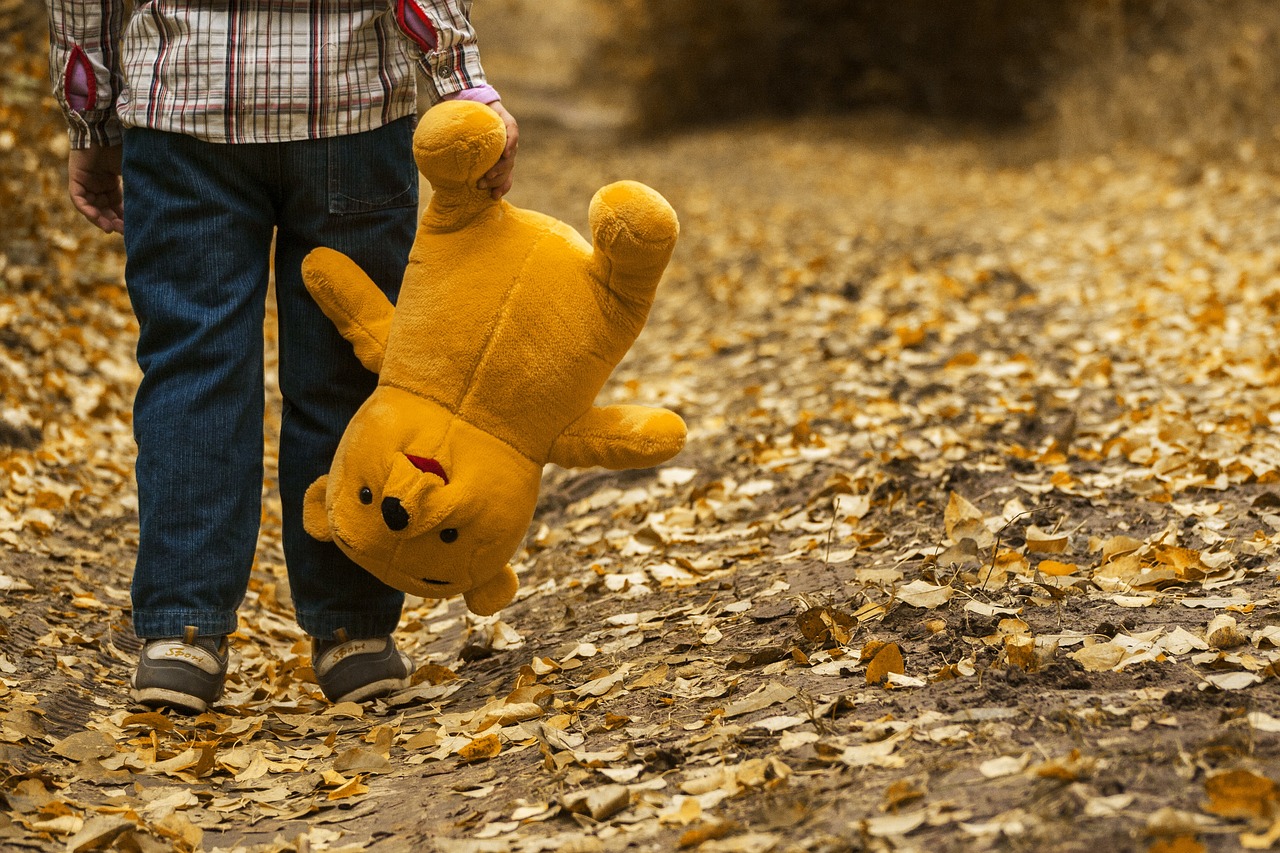 s kid holding a teddy bear